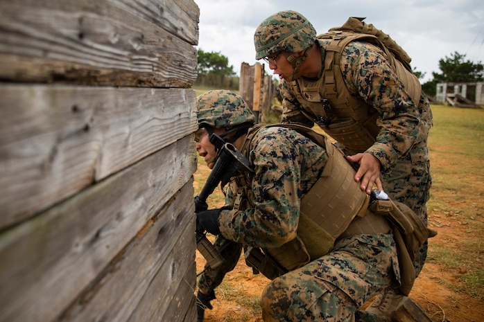 Staff Sgt. Ryan Betonie, right, orders Lance Cpl. Jonathan Zhinin, left, to engage the target during a fire and movement range Oct. 24, 2018, at Camp Hansen, Okinawa, Japan. During the range, Marines with 3rd Marine Logistics Group practiced their marksmanship skills, improved their communication and worked on their weapons handling while engaging targets. Betonie is a native of Lukachukai, Arizona, and is an infantry unit leader with Tactical Readiness and Training, G-3, 3rd MLG Headquarters. Zhinin is a native of Orange, New Jersey, is a food service specialist with Food Service Company, Headquarters Regiment, 3rd MLG. (U.S. Marine Corps photo by Lance Cpl. Terry Wong)