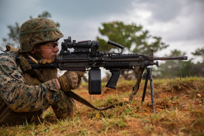 Cpl. Daniel Divirgilio fires a M249 Light Machine Gun at a target during a fire and movement range Oct. 24, 2018, at Camp Hansen, Okinawa, Japan. During the range, Marines with 3rd Marine Logistics Group practiced their marksmanship skills, improved their communication and worked on their weapons handling while engaging targets. Divirgilio is a native of Grafton, Massachusetts, is a machine gunner with the Tactical Readiness and Training, G-3, 3rd MLG Headquarters. (U.S. Marine Corps photo by Lance Cpl. Terry Wong)