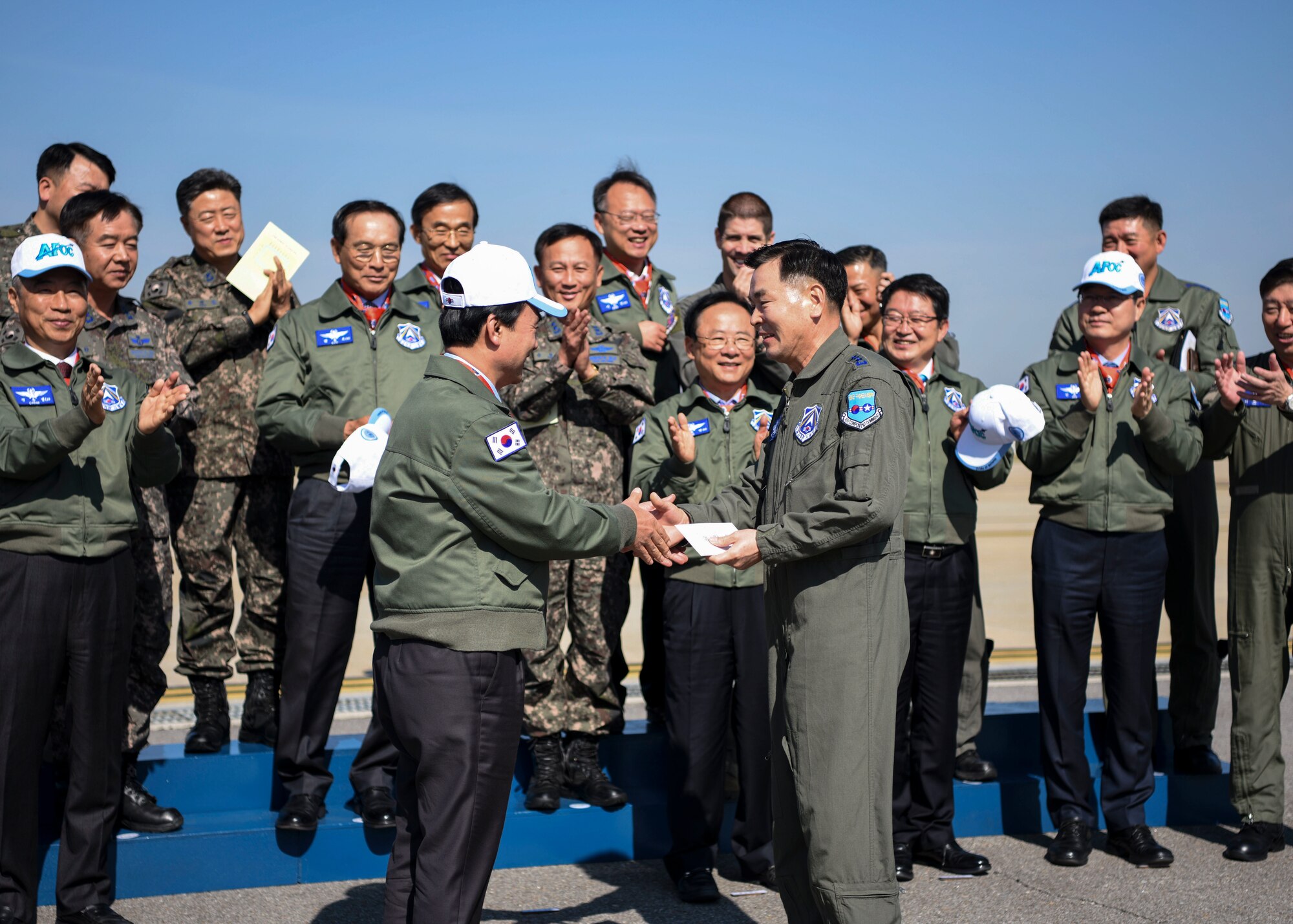Republic of Korea Air Force Lt. Gen. Lee, Keon Wan, Air Force Operations Command commander, receives a gift from Ahn, Gyubaek, National Defense Committee chairman, at Osan Air Base, ROK, Oct. 25, 2018. Members of Team Osan hosted an aircraft and munitions display for the NDC as part of their ROK AFOC site visit. (U.S. Air Force photo by Airman 1st Class Ilyana A. Escalona)