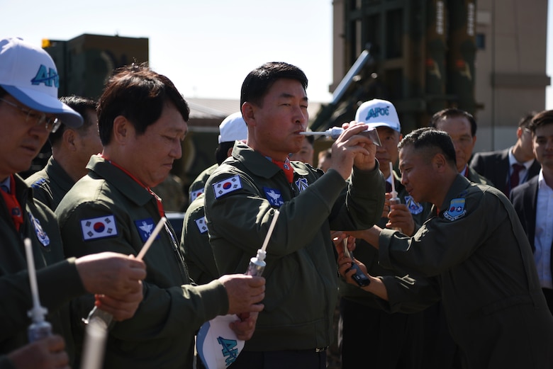 Members of the Republic of Korea National Defense Committee sample liquidized food typically eaten through a tube by U-2 pilots assigned to the 5th Reconnaissance Squadron during long flights at Osan Air Base, ROK, Oct. 25, 2018. U.S. Air Force pilots offered liquid samples of hash browns with bacon, beef stroganoff and chocolate pudding. (U.S. Air Force photo by Airman 1st Class Ilyana A. Escalona)