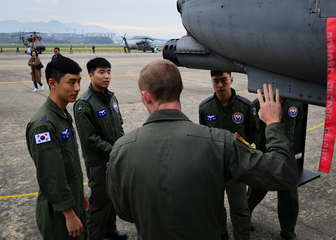 U.S. Air Force Capt. Hunter Hayes, 25th Fighter Squadron A-10 Thunderbolt II pilot, center, talks to Republic of Korea Air Force officers about the GAU 8/A Avenger gun of the aircraft during the Gyeongnam Sacheon Air Expo at Sacheon Air Base, South Korea, Oct. 26, 2018.