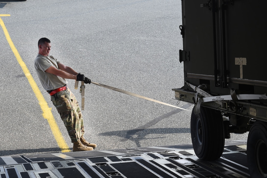 Airmen unload cargo from a C-17