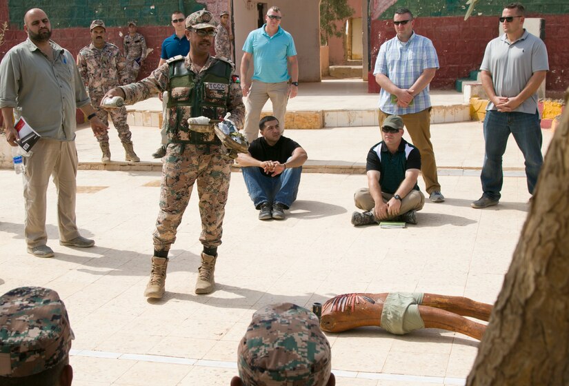 Members of the 157th Military Engagement Team, Wisconsin National Guard, listen attentively to Jordanian Armed Forces WO1 Khaled Al-Samama'h, lead mobile training team instructor, teach a combat life-save course to junior Jordanian Armed Forces, Oct. 7, 18, near Amman, Jordan. Engagements such as these allow collaboration between partner nations to maintain and build positive working relationships.