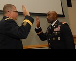 Army Col. Abel Young, right, reaffirms the oath of the commissioned officer with Brig. Gen. Mark Simerly, DLA Troop Support commander, during a promotion ceremony in Philadelphia, Oct. 25, 2018. Young, a Chicago Heights, Ill., native, is the director of DLA Troop Support’s Subsistence supply chain. (Photo by Ed Maldonado/DLA Troop Support)