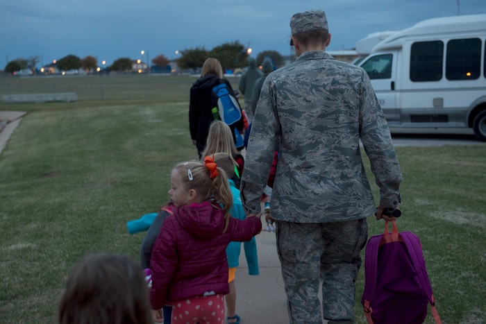 Students of L. Mendel Rivers Elementary School walk to school with teachers and Company Grade Officers, October 24, 2018, at Altus Air Force Base, Okla.
