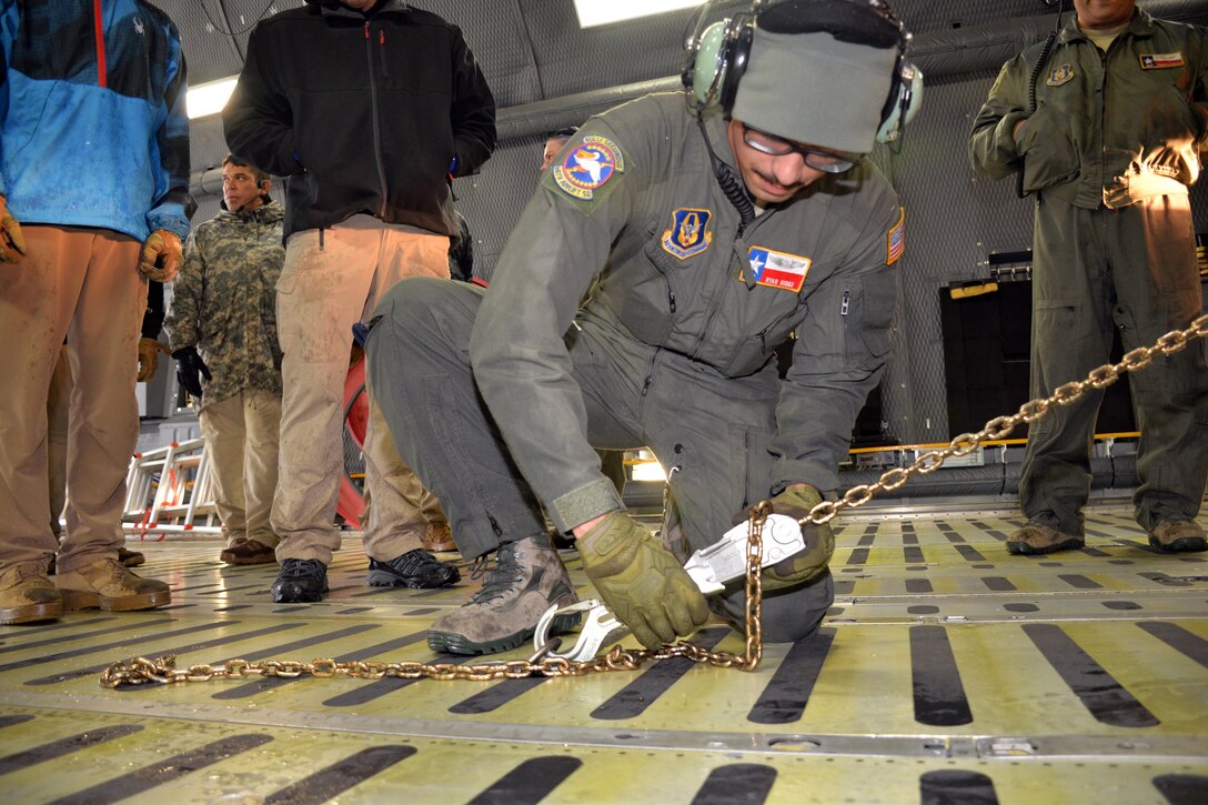 Airman 1st Class Ryan S. Biggs, 68th Airlift Squadron loadmaster, demonstrates how to secure a vehicle with chains and devices in a C-5M Super Galaxy to members of the Texas National Guard 6th Weapons of Mass Destruction Civil Support Team Oct. 24, 2018 at Joint Base San Antonio-Lackland, Texas.