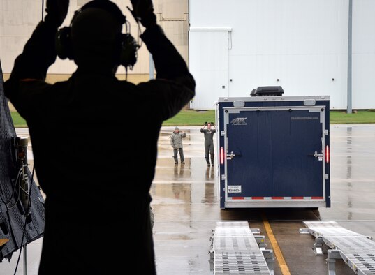 68th Airlift Squadron loadmasters, Airman 1st Class Ryan S. Biggs (left), Tech Sgt. Deb Harper, and Airman Nick Wright, guide a vehicle into a C-5M Super Galaxy Oct. 24, 2018 at Joint Base San Antonio-Lackland, Texas.