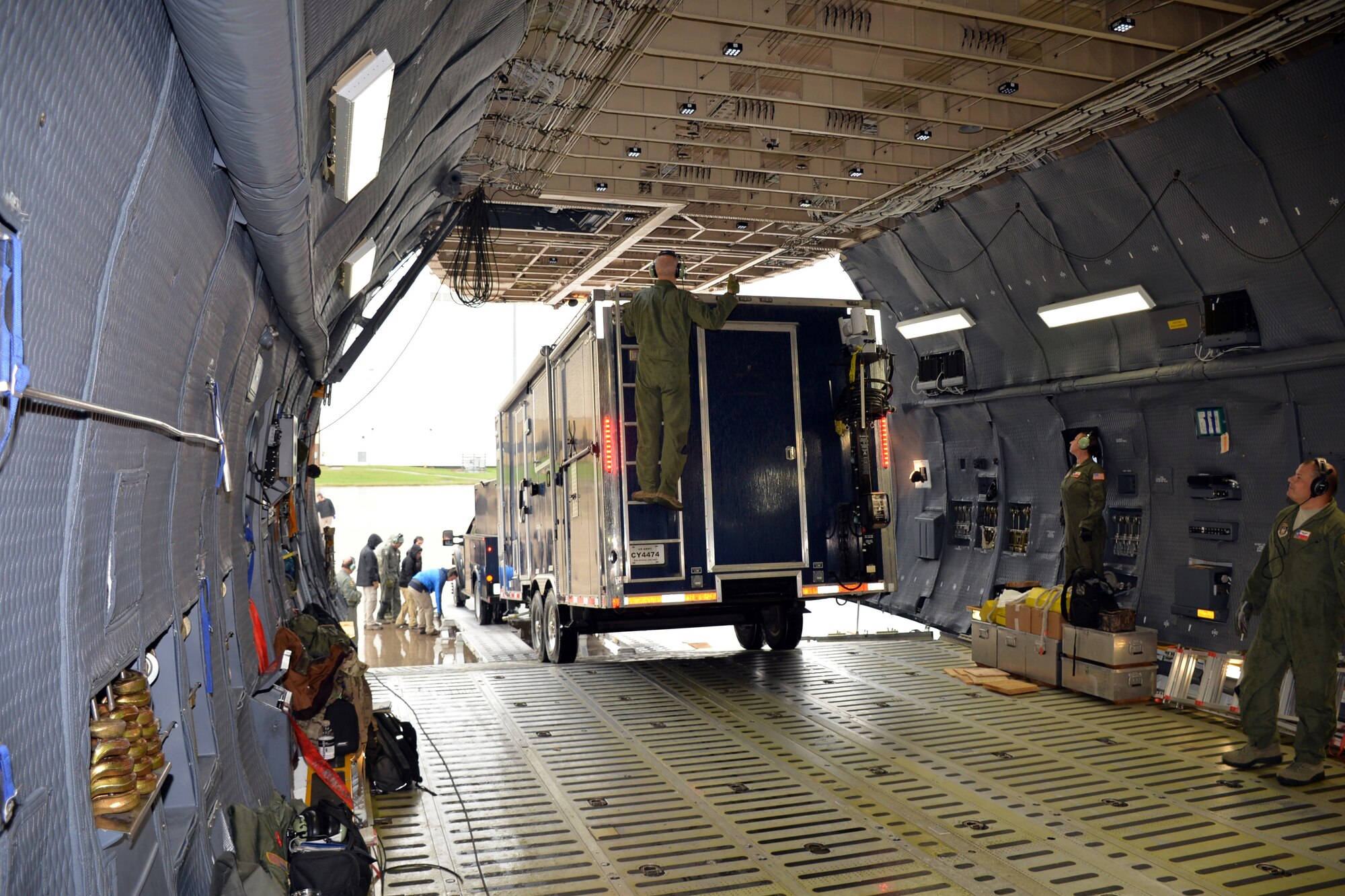 Members of the Texas National Guard 6th Weapons of Mass Destruction Civil Support Team and the 433rd Airlift Wing stop to check clearance while guiding a vehicle into a C-5M Super Galaxy Oct. 24, 2018 at Joint Base San Antonio-Lackland, Texas.