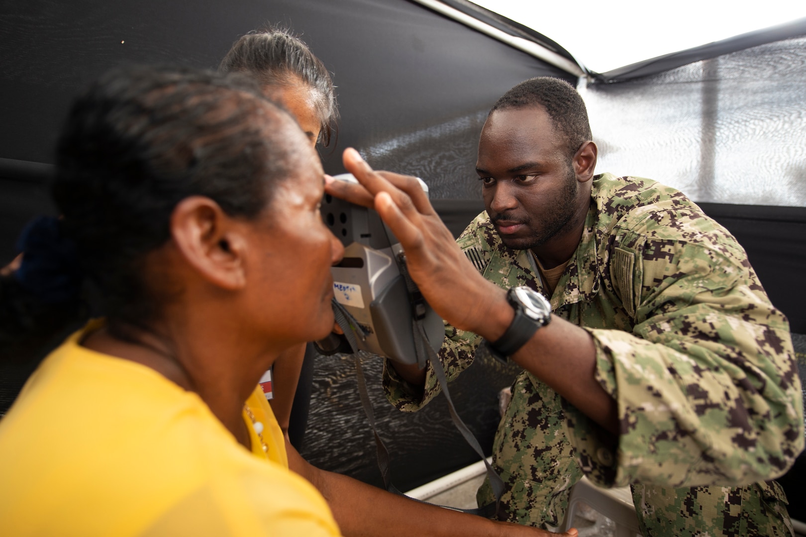 Hospital Corpsman 3rd Class Brandon Williams checks a patient’s eyesight in Ecuador.