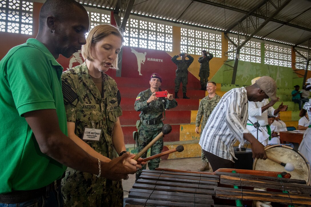 A U.S. Navy Sailor learns to play a D'Luca.