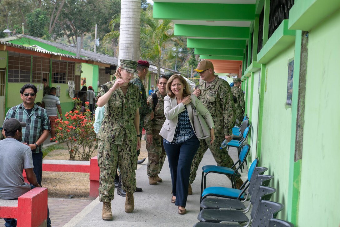 Lt. Cmdr. Amanda Antonio, officer-in-charge of one of two medical sites, escorts Ambassador Liliana Ayalde, civilian deputy to the commander, foreign policy advisor, U.S. Southern Command, around the medical site.