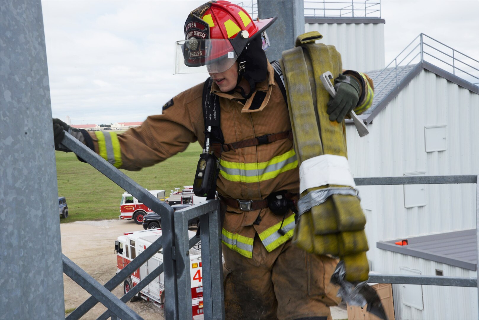 Staff Sgt. Justin Phelps, 902nd Civil Engineer Squadron lead firefighter, races up the stairs while carrying a hose during the firefighter fitness challenge portion of the Battle of the Badges competition Oct. 20, 2018, at Joint Base San Antonio-Randolph’s Camp Talon. Firefighters and security forces members from Joint Base San Antonio locations have competed in Battle of the Badges for the past three years. The initiative was designed to build stronger bonds between the agencies and has become a tradition for the unit members, their families and friends.