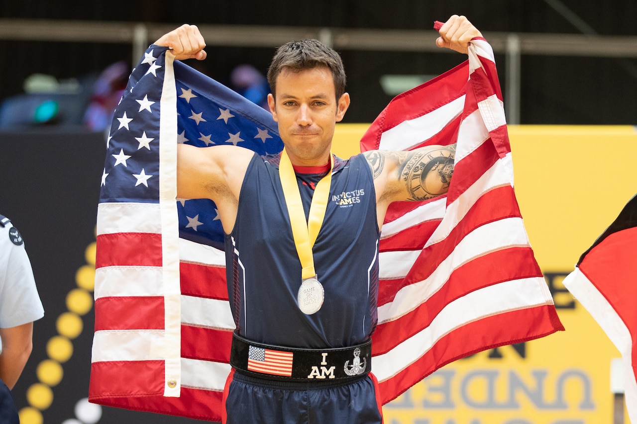 A soldier celebrates winning second place in the lightweight powerlifting competition.