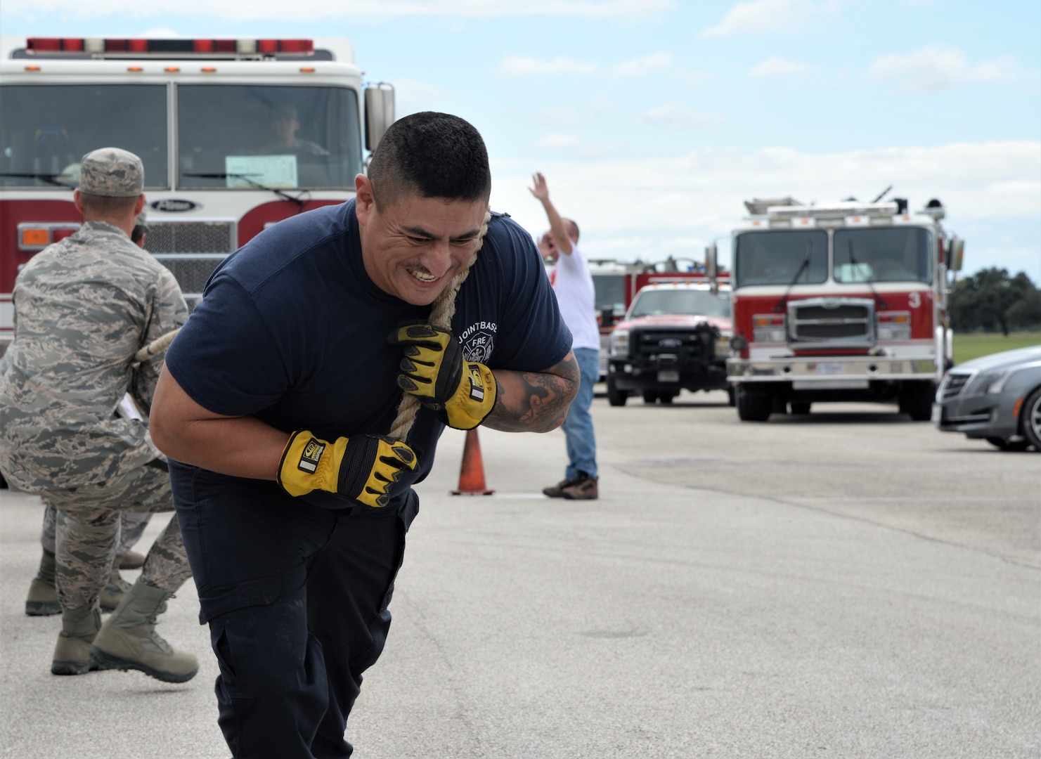 Ramiro Camarillo, 502nd Civil Engineer Squadron lead firefighter, and 502nd CES firefighters pull a fire truck Oct. 20, 2018, during the final challenge of the 2018 Battle of the Badges at Joint Base San Antonio-Randolph. Battle of the Badges takes place each year to build camaraderie, espirit de corps and cohesion among JBSA first responders through various competitive challenges taken from their daily missions.