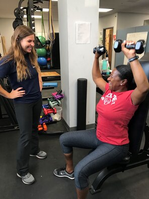 Ashley Kessler United States Air Force School of Aerospace Medicine research athletic trainer (left), coaches Maj. Pamela Paulin, USAFSAM Public Health consultant, during her training session. (U.S. Air Force photo/Stacey Geiger)