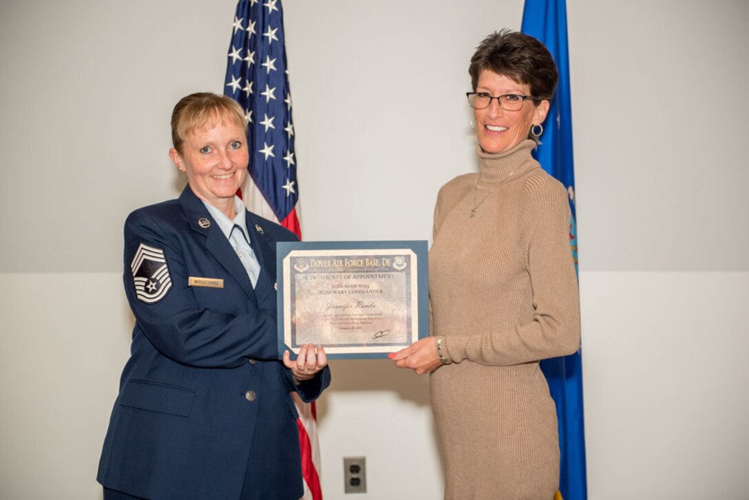 Chief Master Sgt. Marti Widdicombe, 512th Aircraft Maintenance systems manager, presents an honorary commander certificate to Jennifer Rambo, honorary commander inductee for the 512th Aircraft Maintenance Squadron during the Honorary Commander Induction ceremony at Dover Air Force Base, Delaware, Oct. 20, 2018. Rambo is the director of marketing for Mission BBQ. (U.S. Air Force photo by Staff Sgt. Damien Taylor)