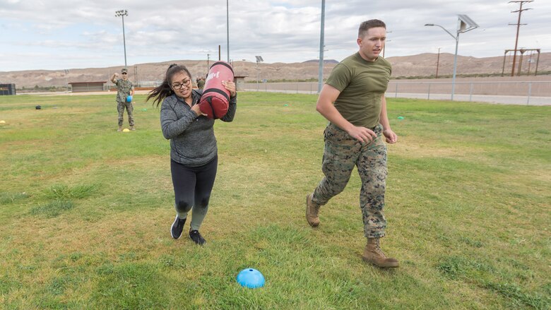 Sgt. Benjamin Crouch, Supply Administrator, runs with his wife, Blanca Crouch, during the Combat Fitness Test event during Jane Wayne Day aboard Marine Corps Logistics Base Barstow, Calif., Oct. 12. 
(U.S. Marine Corps Photo by Jack J. Adamyk)