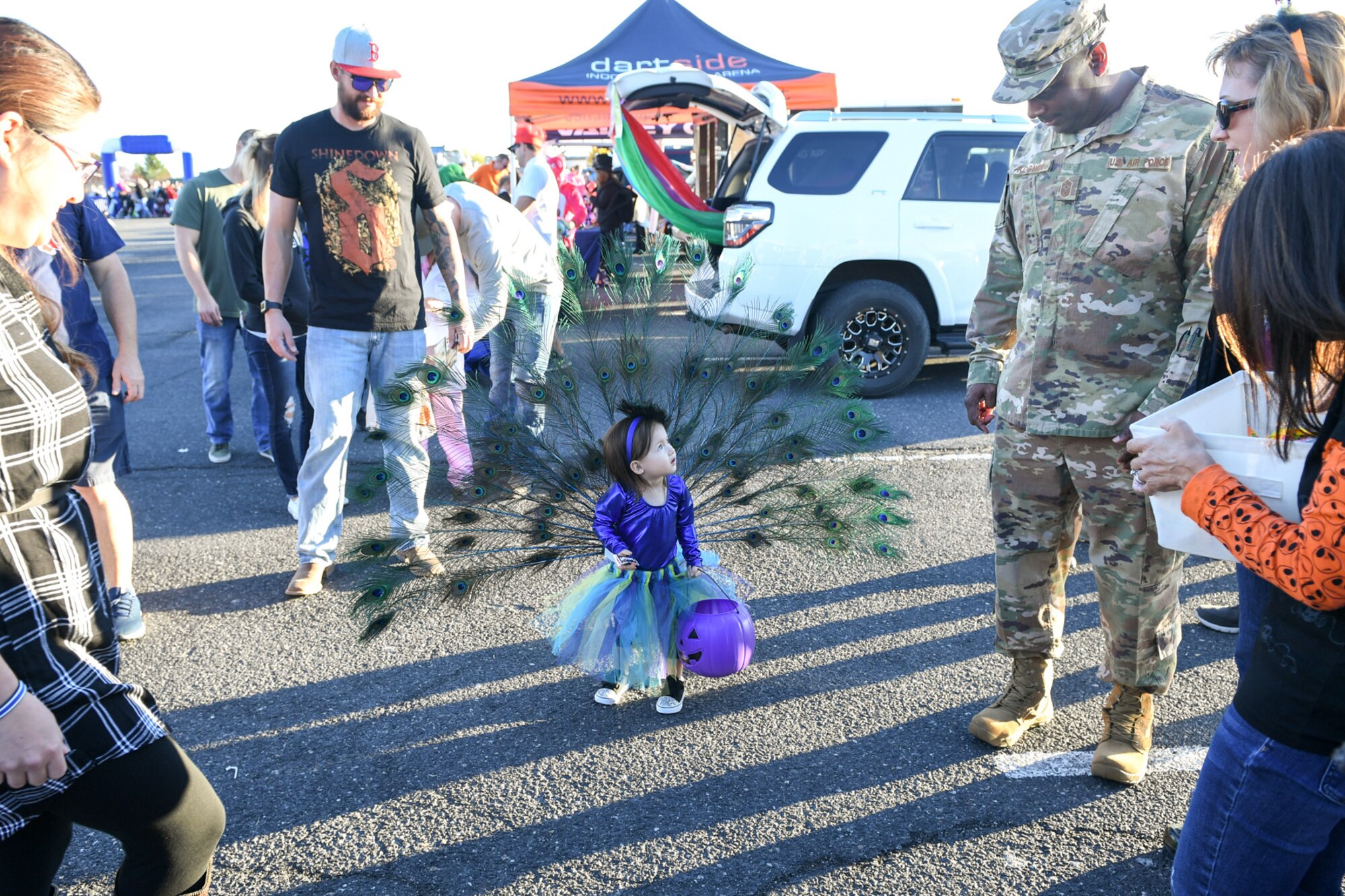 Chief Master Sgt. Rodney Koonce, 75th Air Base Wing Command Chief is approached by Miya Suiter in her handmade peacock costume during the Haunting on the Hill celebration Oct. 19, 2018 at Hill Air Force Base, Utah. (U.S. Air Force photo by Cynthia Griggs)