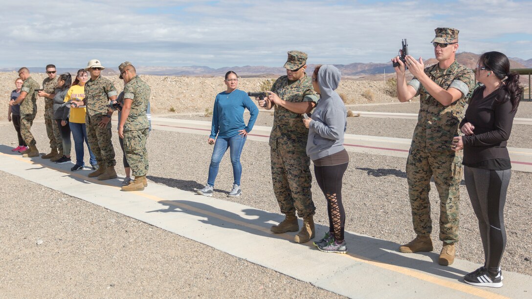 Marines instruct military and civilian spouses through a preliminary marksmanship instruction course of weapons handling, before competing in the Pistol Qualification/Shootout event of Jane Wayne Day aboard Marine Corps Logistics Base Barstow, Calif,, Oct. 12.
(U.S. Marine Corps Photo by Jack J. Adamyk)