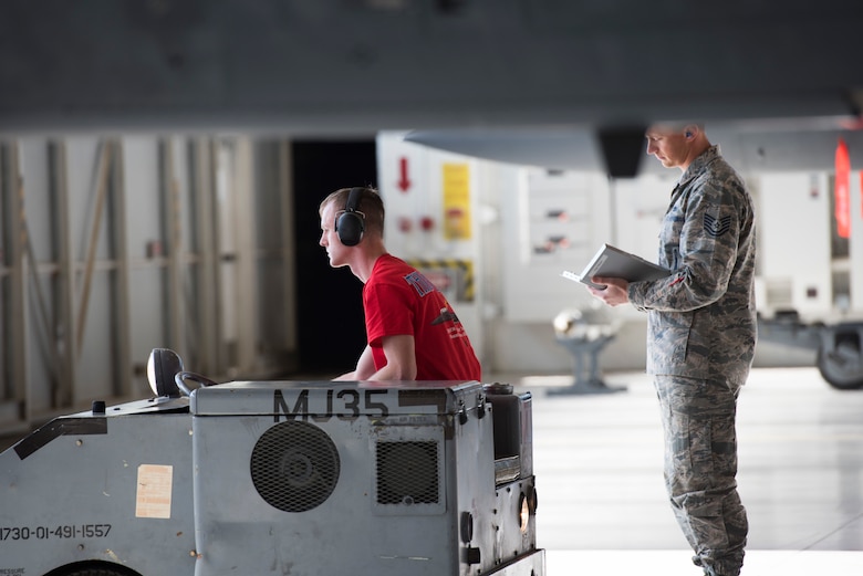 Image of Airman 1st Class Timothy Ponzi, 389th Fighter Squadron weapons load crew member, is inspected as he operates a jammer during a load competition, Oct. 18, 2018, at Mountain Home Air Force Base, Idaho. During the load competition, Ponzi's job tasks included driving a jammer and helping lift and load a munition. (U.S. Air Force photo by Senior Airman Alaysia Berry)