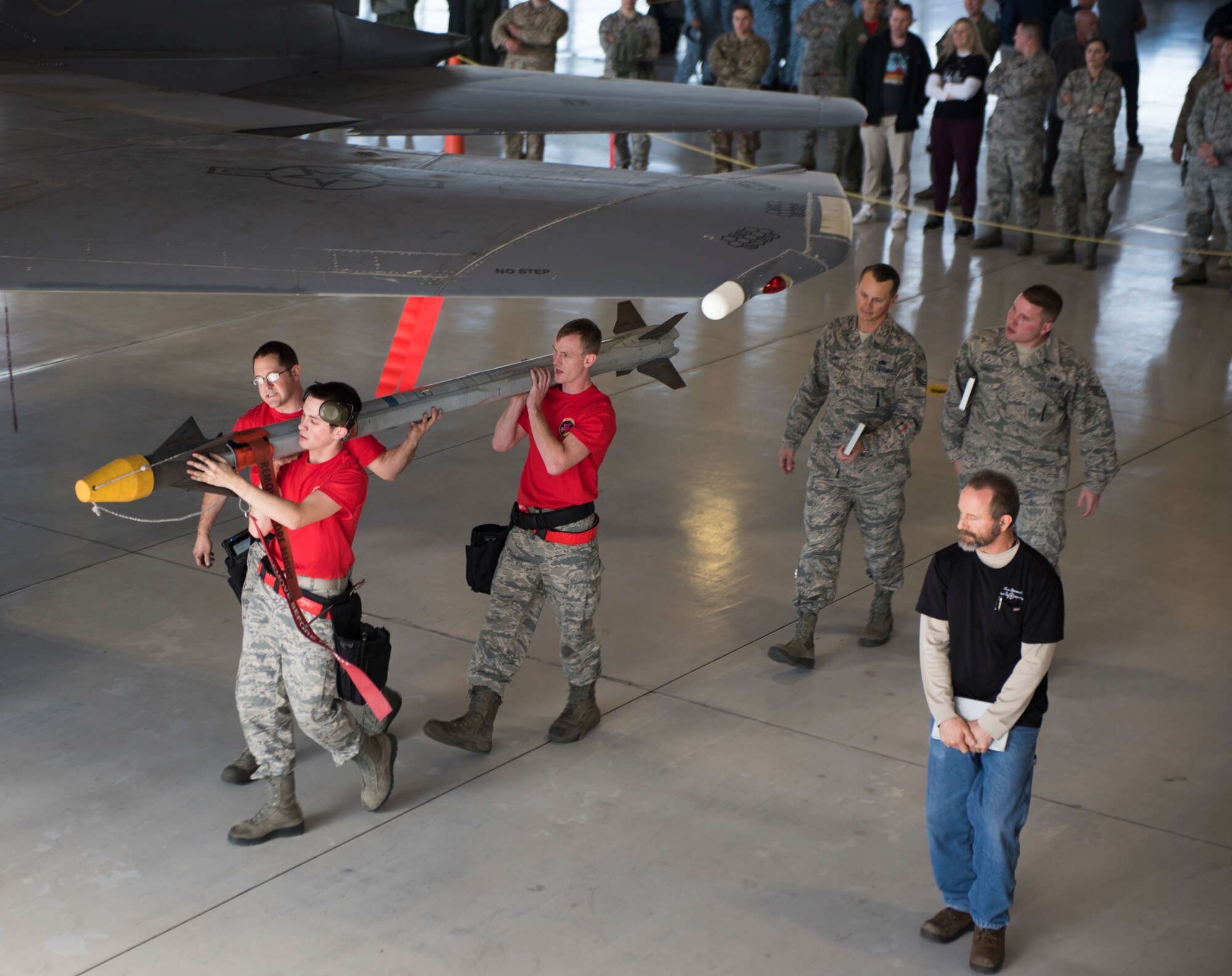 Image of Members of the 389th Fighter Squadron carry a munition toward their jet during a weapons loading competition, Oct. 18, 2018, at Mountain Home Air Force Base, Idaho. The purpose of the competition is to simulate pressures of a deployed environment and instill pride and morale. (U.S. Air Force photo by Senior Airman Alaysia Berry)