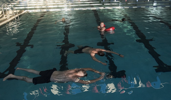 Sailors demonstrate the survival float during a second-class swim qualification test Oct. 19, 2018, at the Danny Jones Recreational Center, North Charleston, S.C.