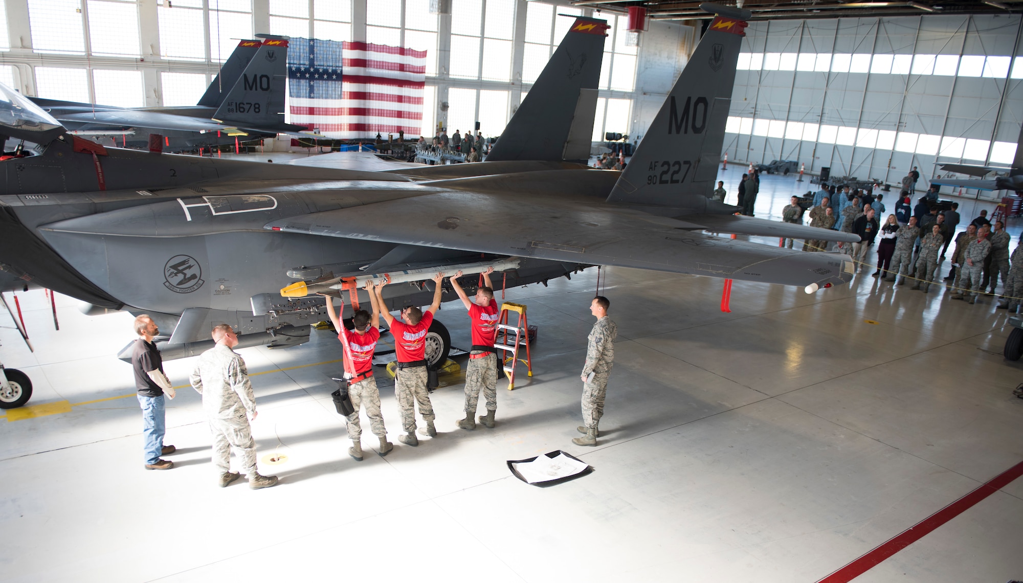 Image of Members of the 389th Fighter Squadron lift a munition onto their jet during a weapons loading competition, Oct. 18, 2018, at Mountain Home Air Force Base, Idaho. The purpose of the competition is better prepare Airmen for the pressures of a deployed situation. (U.S. Air Force photo by Senior Airman Alaysia Berry)