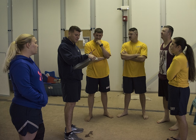 U.S. Navy Master-at-Arms 2nd Class Bryan Mead, 628th Security Forces Squadron Harbor Patrol Unit, gives a safety briefing to Sailors during a second-class swim qualification test Oct. 19, 2018, at the Danny Jones Recreational Center, North Charleston, S.C.