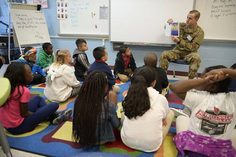 Senior Airman Luke Hamilton, 628th Comptroller Squadron comptroller, reads to students at Pepperhill Elementary School Oct. 24, 2018 in North Charleston, S.C. Airmen from the 628th CPTS went to the school to read to children and answer any questions the children had about being an Airmen.