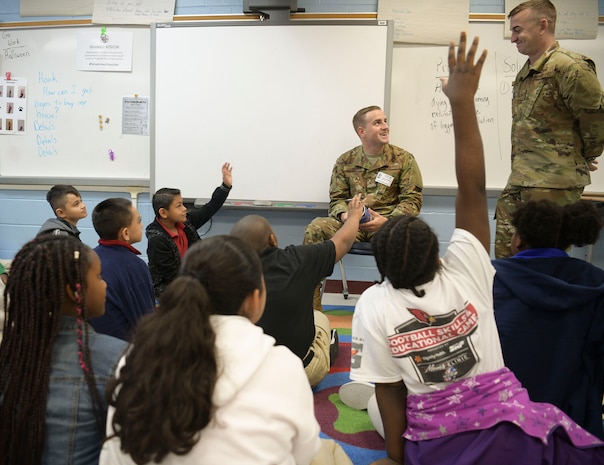 Senior Airman Luke Hamilton (left), 628th Comptroller Squadron comptroller, and Staff Sgt. Jordan Stinson, 628th CPTS budget analyst, answer students’ questions at Pepperhill Elementary School Oct. 24, 2018 in North Charleston, S.C. Airmen from the 628th CPTS went to the school to read to children and answer any questions the children had about being an Airmen.