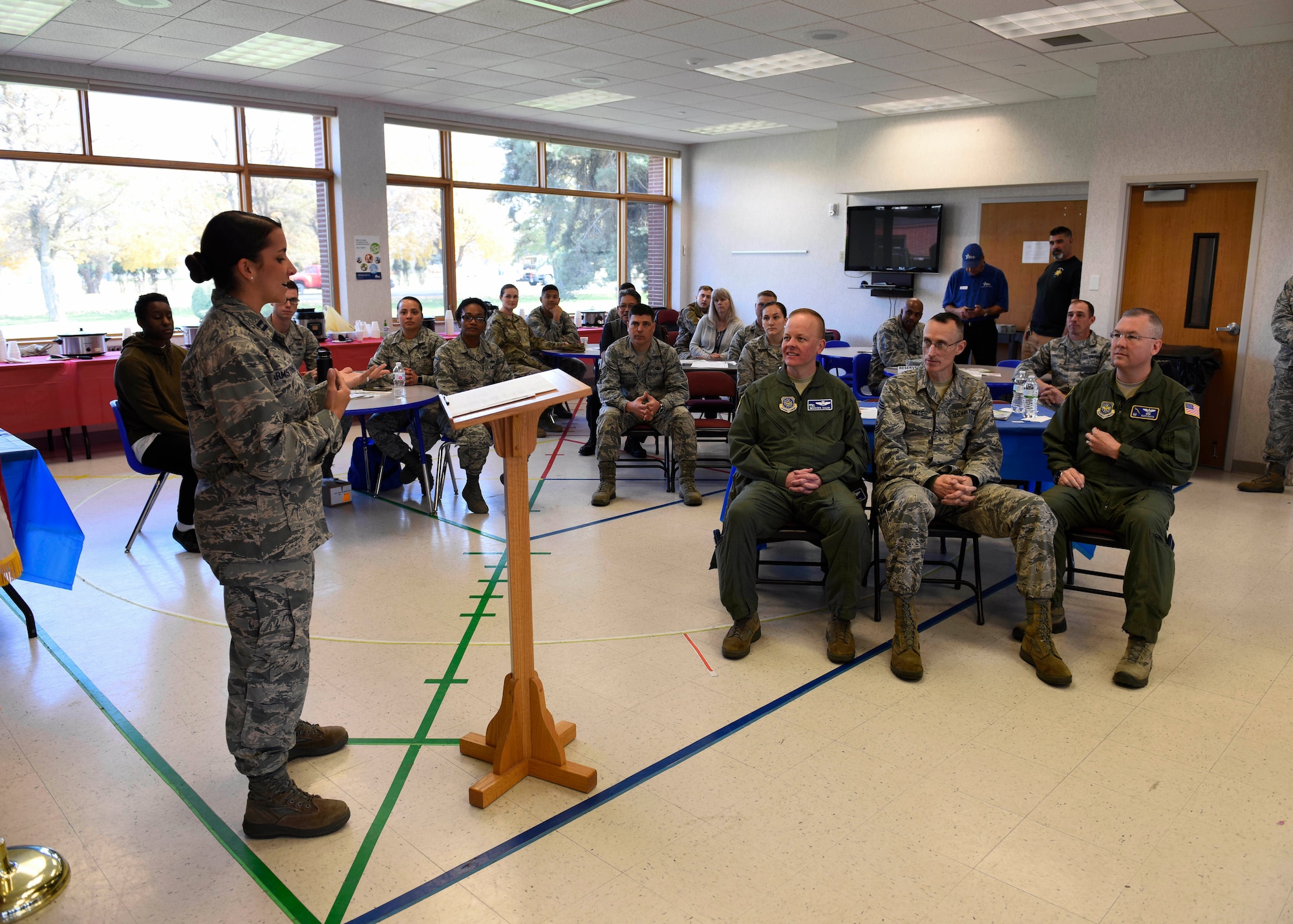 Capt. Alyssa Armstrong, 92nd Logistics Readiness Squadron Material Management Flight commander, gives opening remarks for a "Chili Cook-Off" event promoting the 2018 Combined Federal Campaign Kick-Off at Fairchild Air Force Base, Washington, Oct. 24, 2018.  Fairchild's 92nd Air Refueling Wing CFC representatives hosted a "Chili Cook-Off" event, allowing Airmen to engage with local charities and nonprofit organizations. (U.S. Air Force photo/Airman 1st Class Lawrence Sena)