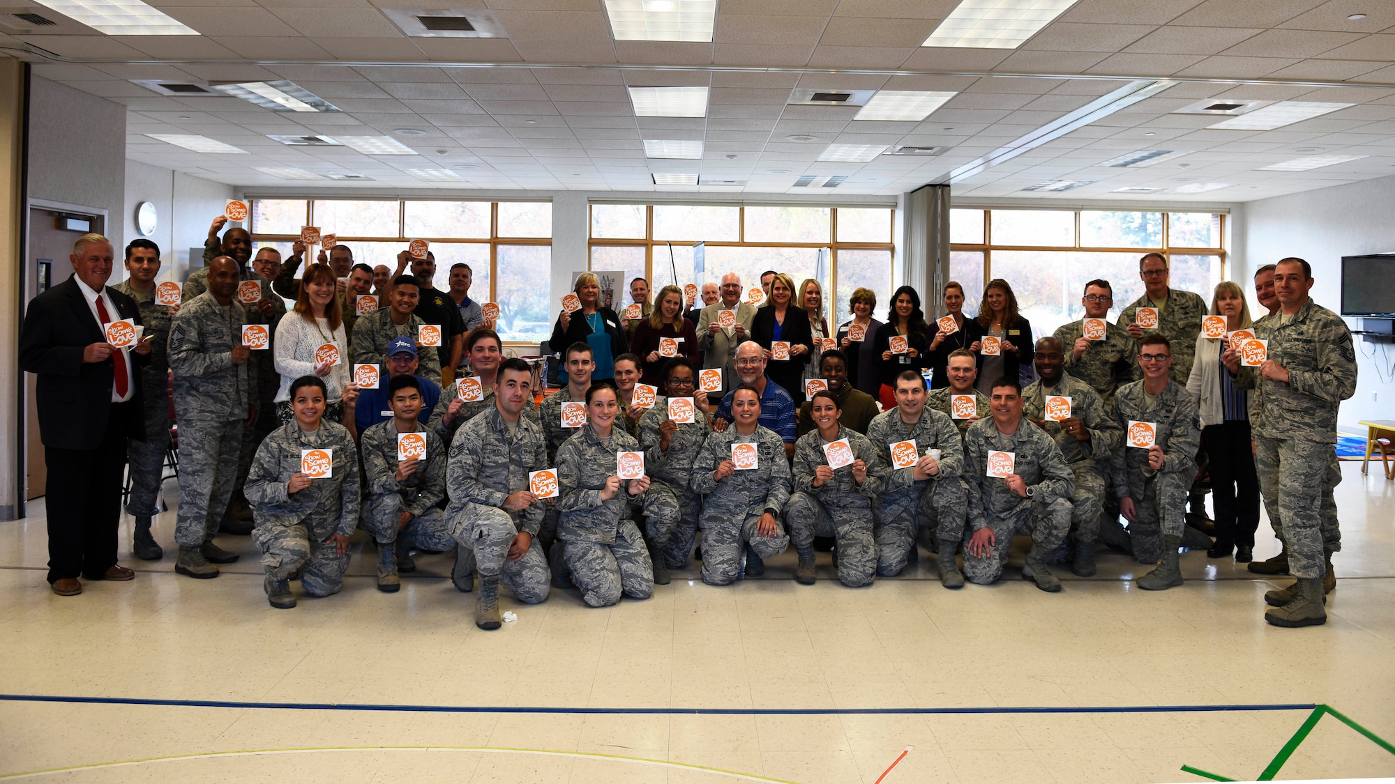 Airmen and representatives from local charities and nonprofit organizations pose for a photo as part of a "Chili Cook-Off" event promoting the 2018 Combined Federal Campaign Kick-Off at Fairchild Air Force Base, Washington, Oct. 24, 2018. Nine local charities and nonprofit organizations were represented at the event, giving them the opportunity to engage with the Airmen who attended. (U.S. Air Force photo/Airman 1st Class Lawrence Sena)