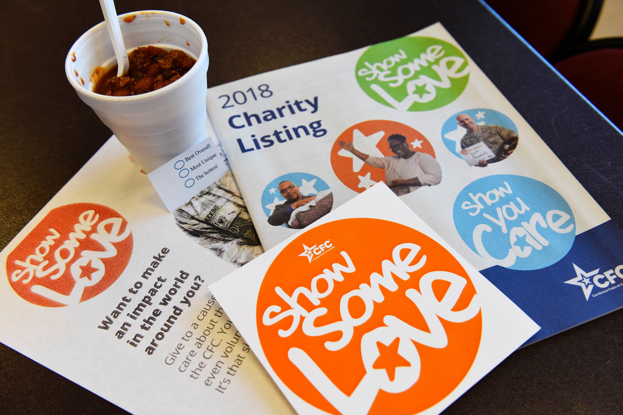 Combined Federal Campaign catalogs and donation documents rest next to a cup of chili during a "Chili Cook-Off" event promoting the 2018 CFC Kick-Off at Fairchild Air Force Base, Washington, Oct. 24, 2018. The mission of the CFC is to promote and support philanthropy through a program that is employee-focused, cost-efficient and effective in providing all federal employees the opportunity to contribute to local charities and nonprofit organizations of their choice. (U.S. Air Force photo/Airman 1st Class Lawrence Sena)