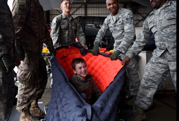 A  child is in a blue and white bag.