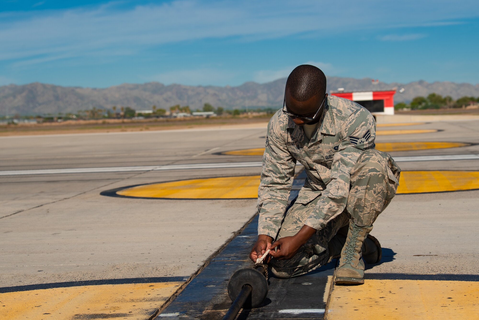 Senior Airman Derrick Beleski, 56th Operation Support Squadron airfield management operations supervisor, looks over a safety cable system, Oct. 24, 2018, at Luke Air Force Base, Ariz.