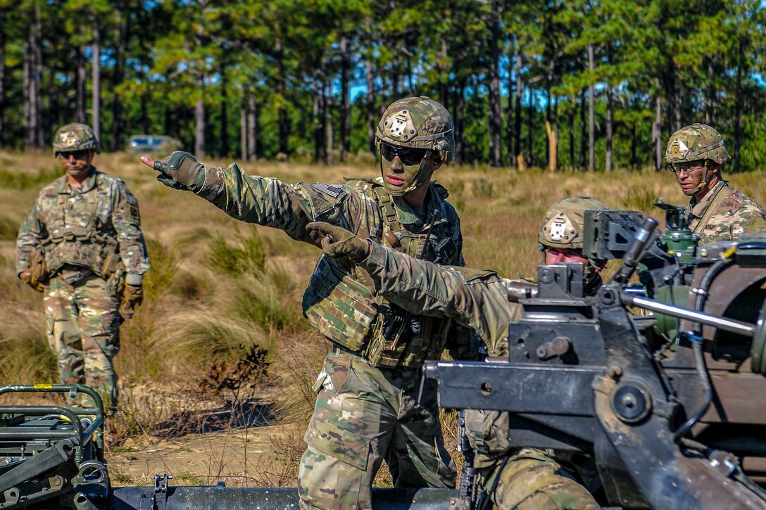 Paratroopers line up a howitzer.