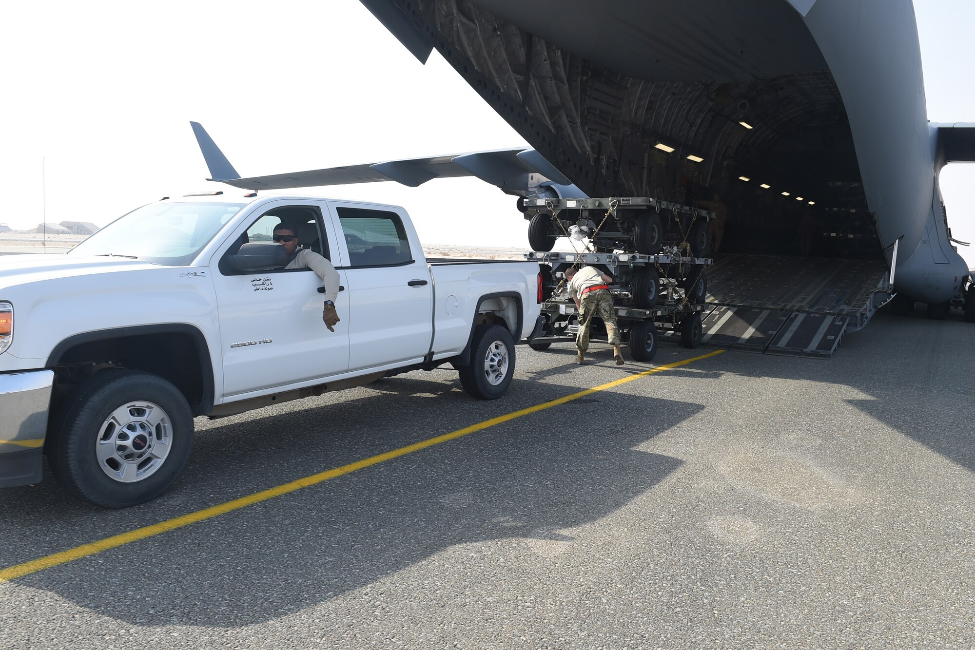 Airmen unload cargo from a C-17