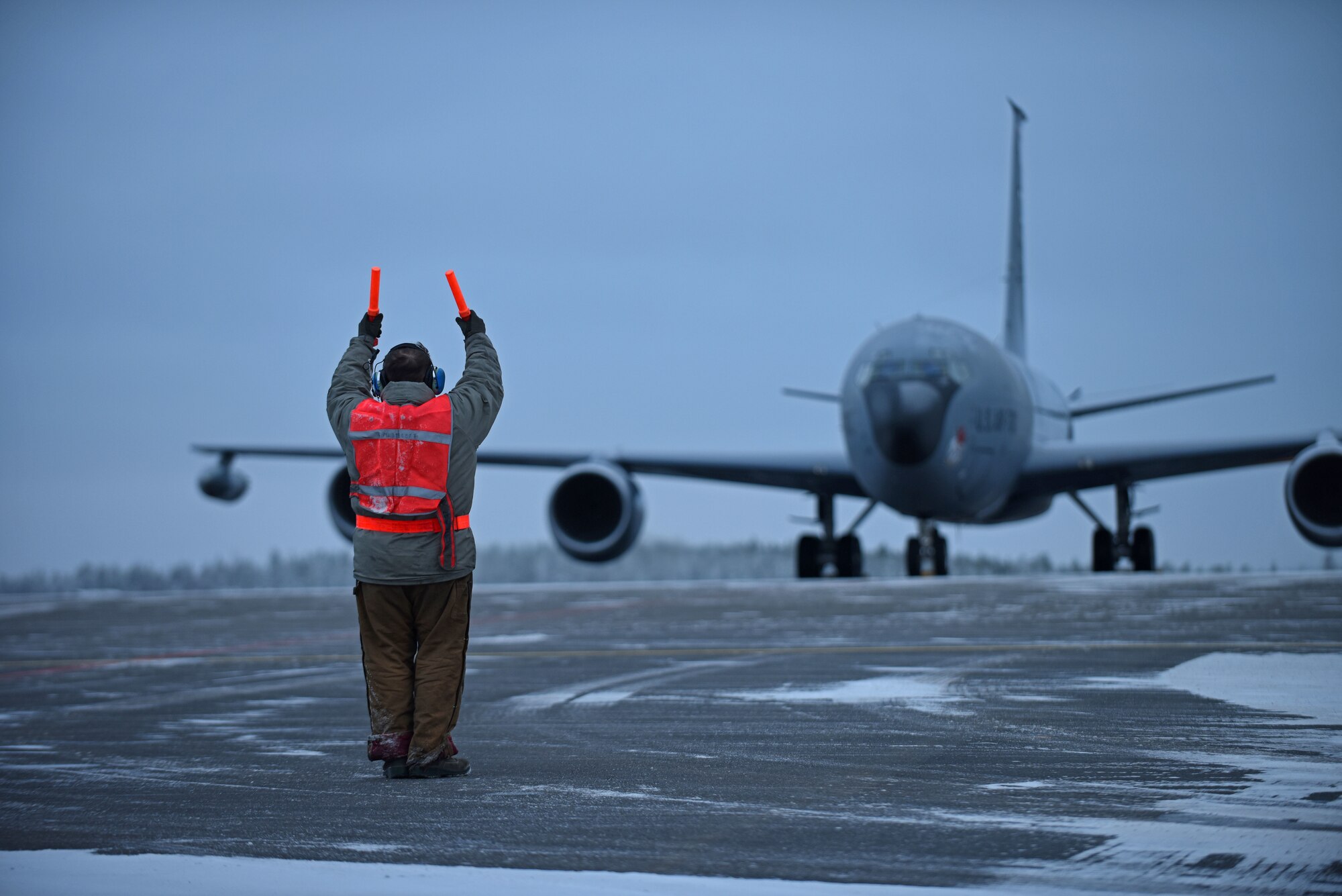 U.S. Air Force Senior Airman Nicholas Vidmar, 100th Aircraft Maintenance Squadron crew chief, marshals a U.S. Air Force KC-135 Stratotanker before takeoff to conduct aerial refueling training during Exercise Trident Juncture 18, at Rovaniemi, Finland, Oct. 27, 2018. Trident Juncture is the largest NATO exercise since 2015, with more than 50,000 military members from 31 nations. The U.S. military makes up approximately a quarter of the participating personnel. (U.S. Air Force photo by Senior Airman Luke Milano)