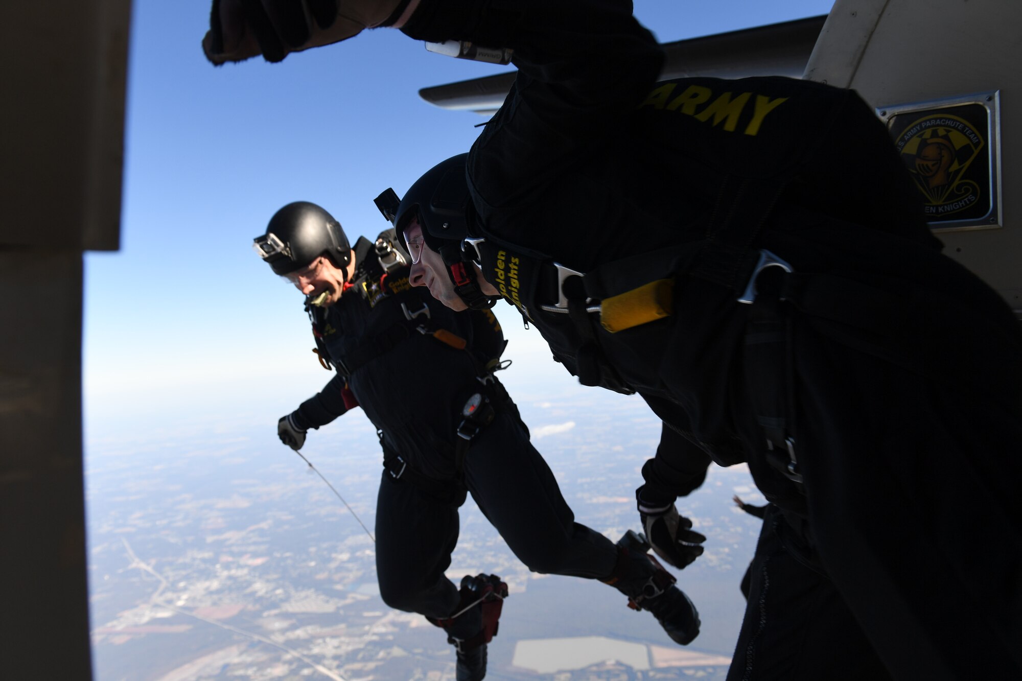 A member of the U.S. Army Golden Knights jumps out of the slide of an aircraft