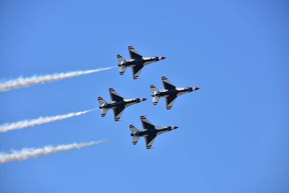 A group of U.S. Air Force Thunderbird aircraft fly in formation
