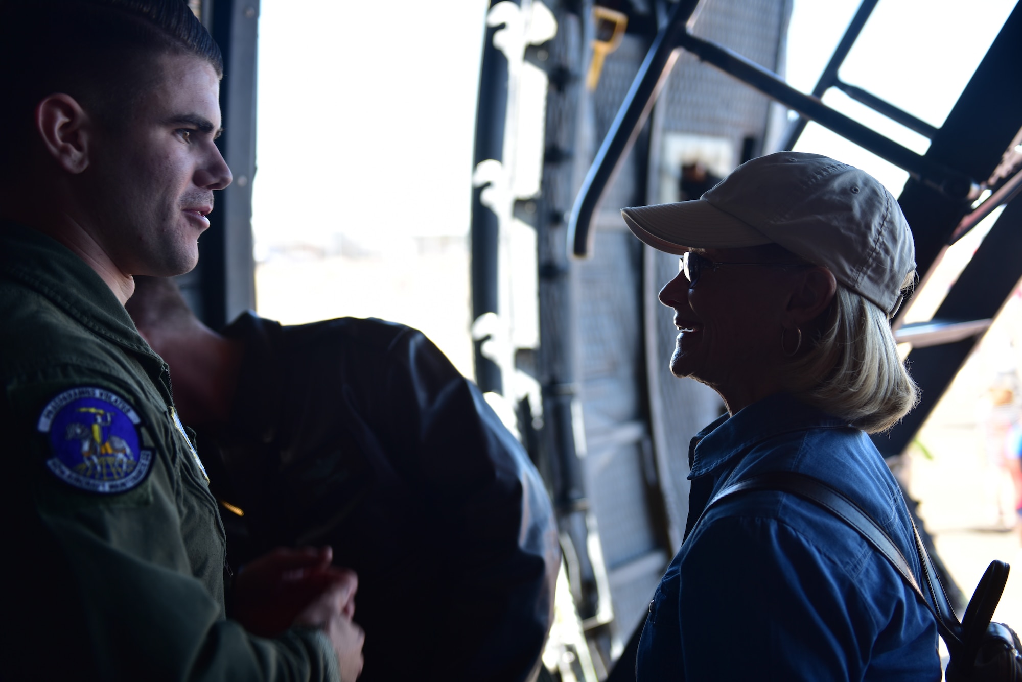 A male speaks to a female on an aircraft during an air show