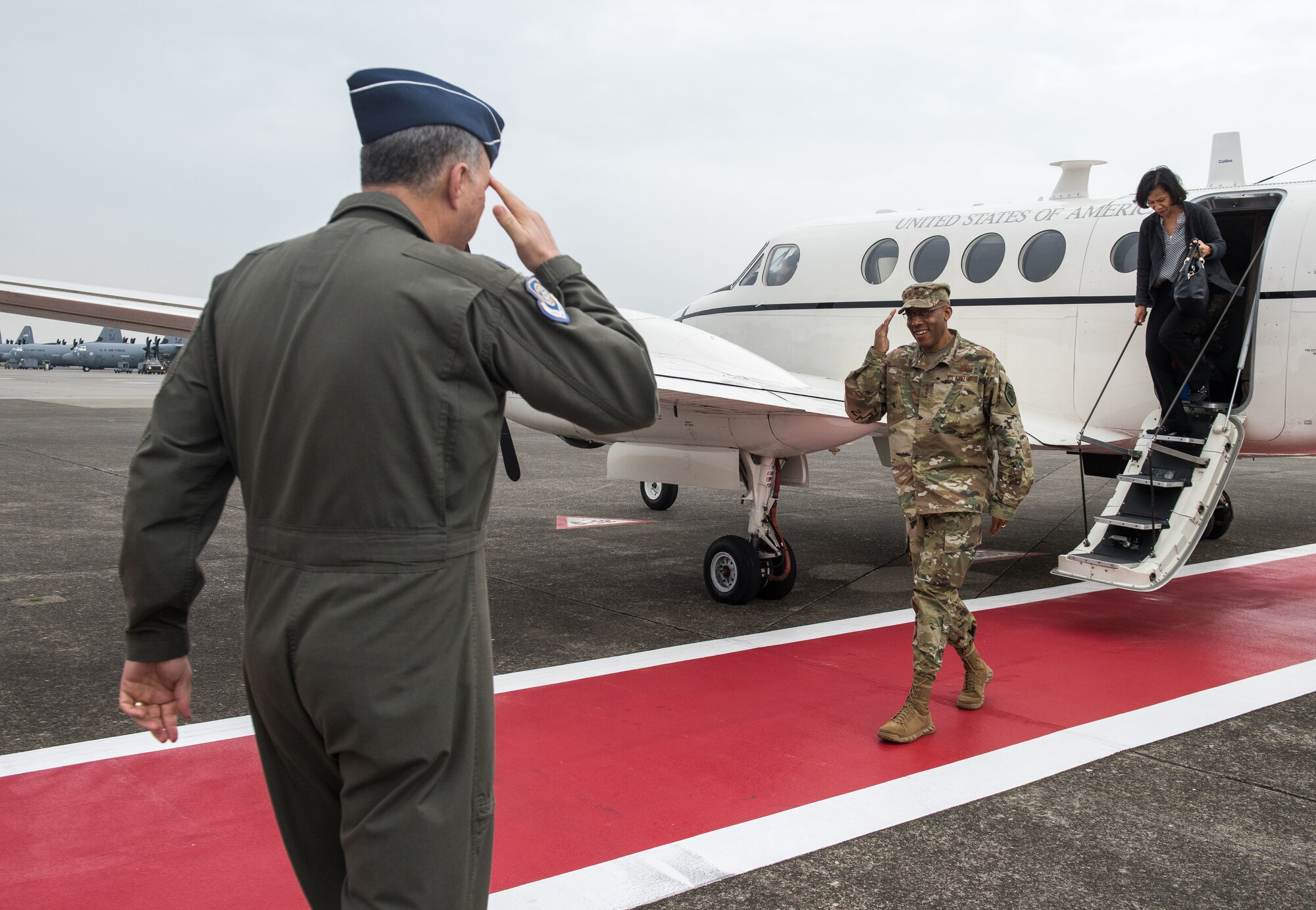 U.S. Air Force Lt. Gen. Jerry P. Martinez, United States Forces Japan commander, salutes Gen. CQ Brown, Jr., Pacific Air Forces commander, as Brown and his wife, Sharene, arrive at Yokota Air Base