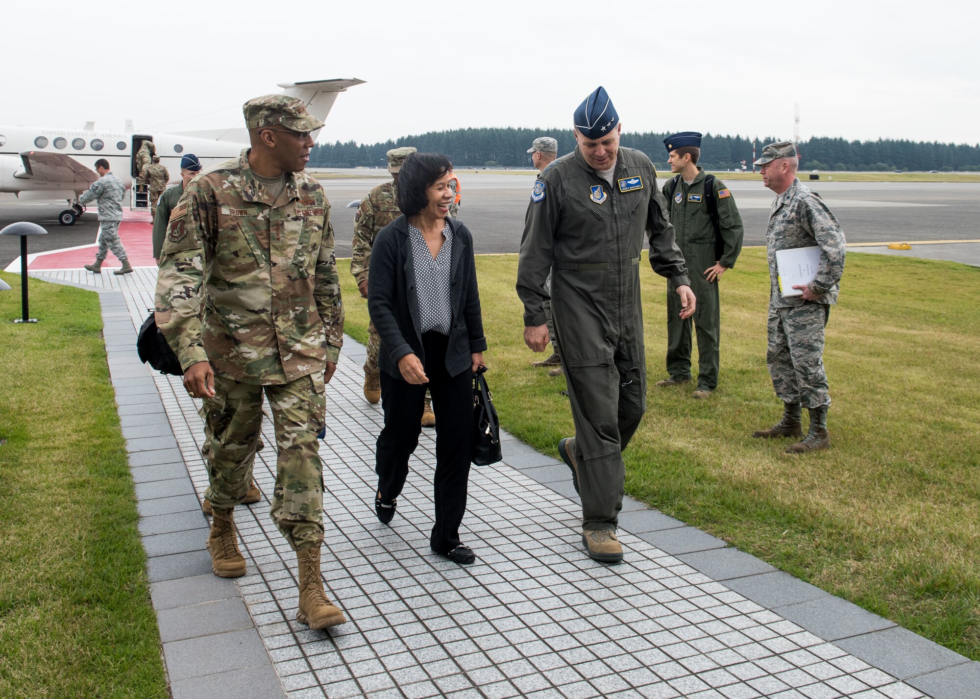 U.S. Air Force Gen. CQ Brown, Jr., Pacific Air Forces commander, his wife, Sharene, and Lt. Gen. Jerry P. Martinez, United States Forces Japan commander, walk to the 374th Distinguished Visitor Lounge