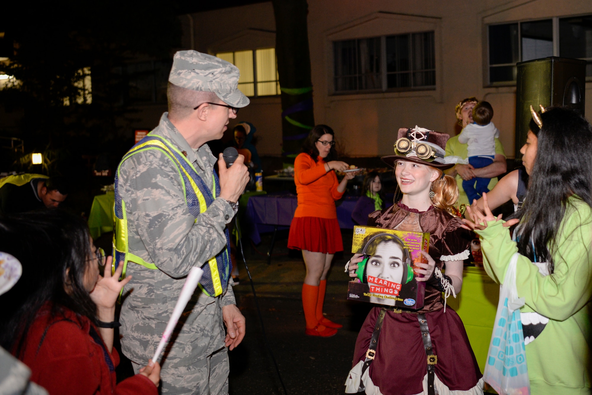 Maj. Kelly Stahl, 374th Airlift Wing chaplain, presents a prize to an event goer during Trunk-or-Treat, Oct. 26, 2018, at Yokota Air Base, Japan.