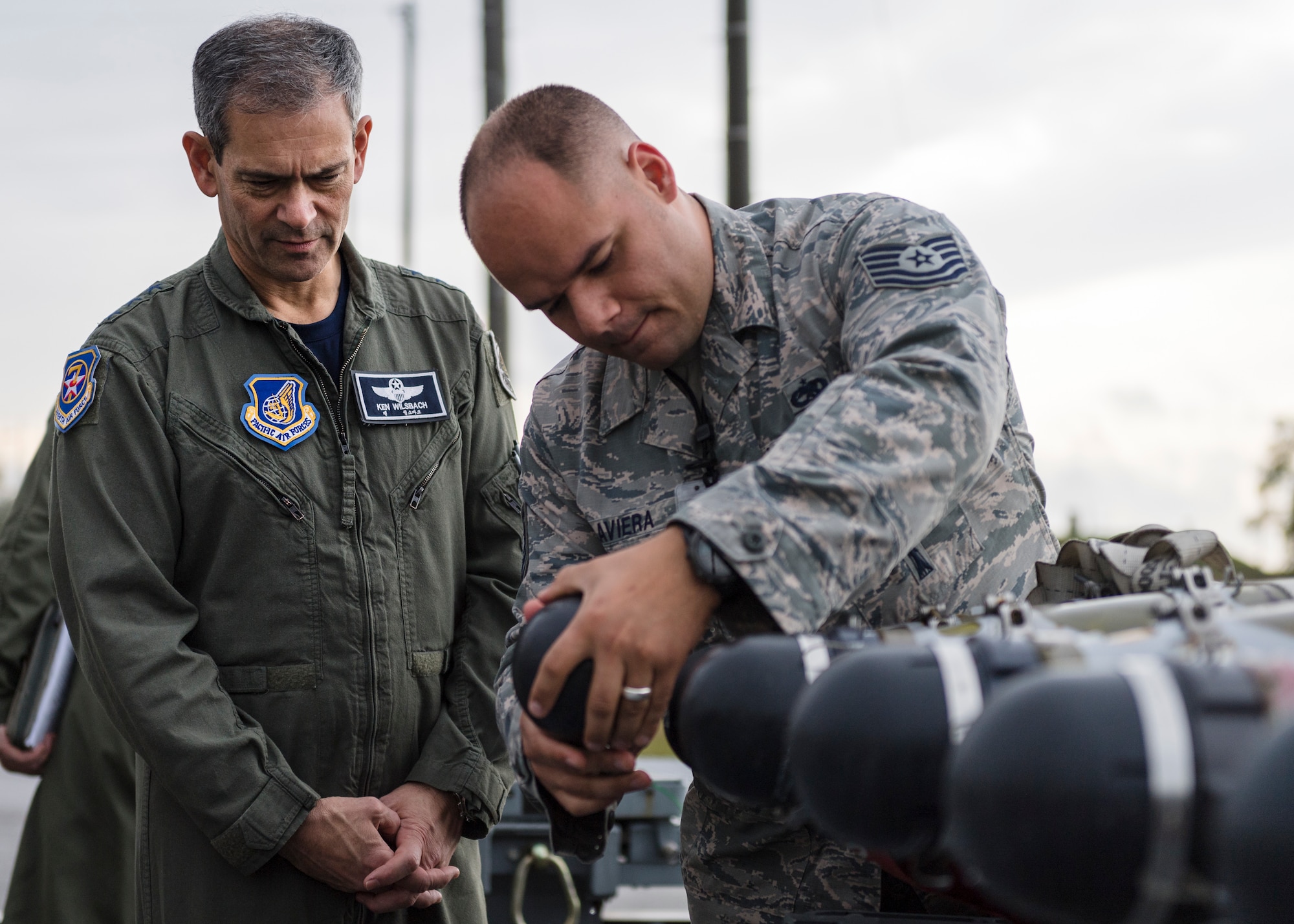 U.S. Air Force Tech Sgt. Humberto Laviera, right, 51st Munitions Squadron conventional maintenance production superintendent, shows Lt. Gen. Kenneth Wilsbach, Seventh Air Force commander, the inside of a munition at Osan Air Base, Republic of Korea, Oct. 26, 2018.  As the new 7th AF commander, Wilsbach toured various units around Osan Air Base to include the 51st MUNS, 51st Aircraft Maintenance Squadron, and the 25th and 36th Fighter Squadrons.  (U.S. Air Force photo by Staff Sgt. Rachel Maxwell)