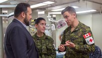 Tyler Wordsworth, senior trade commissioner, Embassy of Canada, talks with Canadian military members.