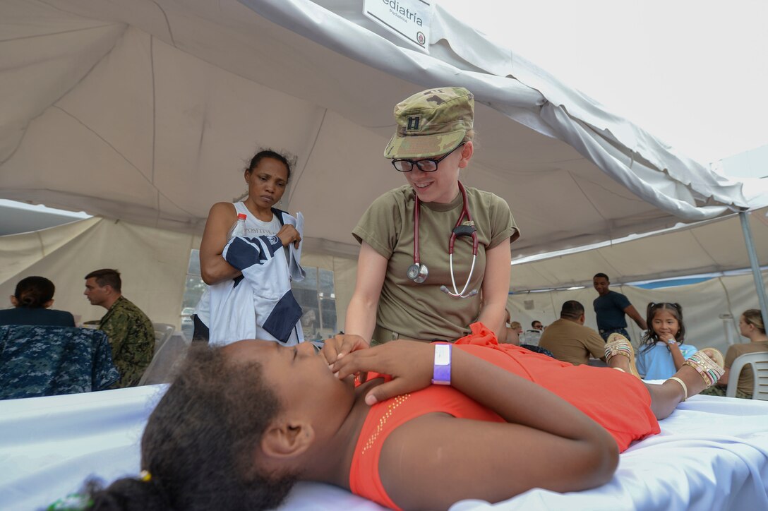 Army Capt. Christin Folker treats a patient in Ecuador.