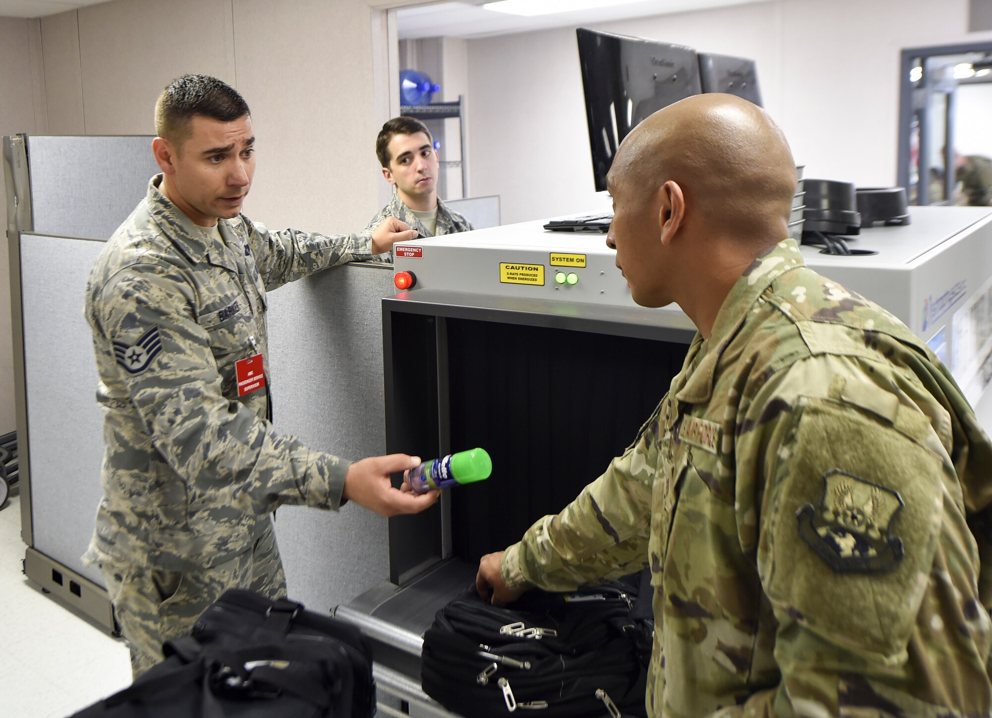 Staff Sgt. James Barker, 437th Aerial Port Squadron passenger operations supervisor, removes an unauthorized item from a bag at a security checkpoint Oct. 15, 2018.