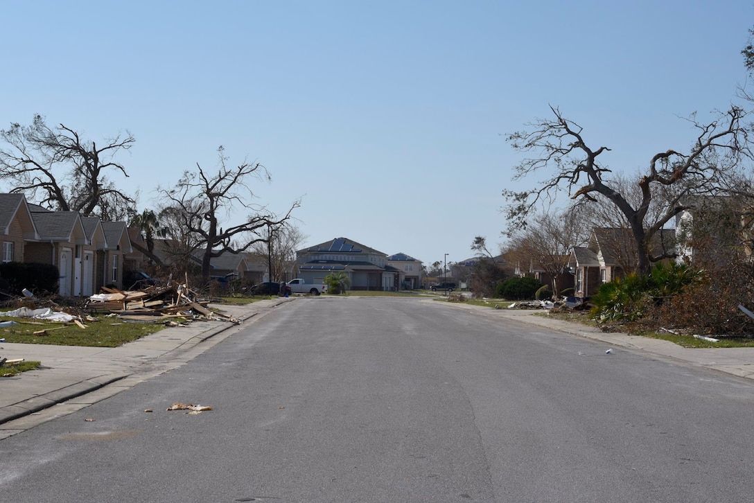 A residential street in base housing is stricken with damage Oct. 18, 2018 at Tyndall Air Force Base, Fla. In the aftermath of Hurricane Michael, the Krietes relied on the Air Force and each other to overcome adversity. (U.S. Air Force photo by Airman 1st Class Dalton Williams)