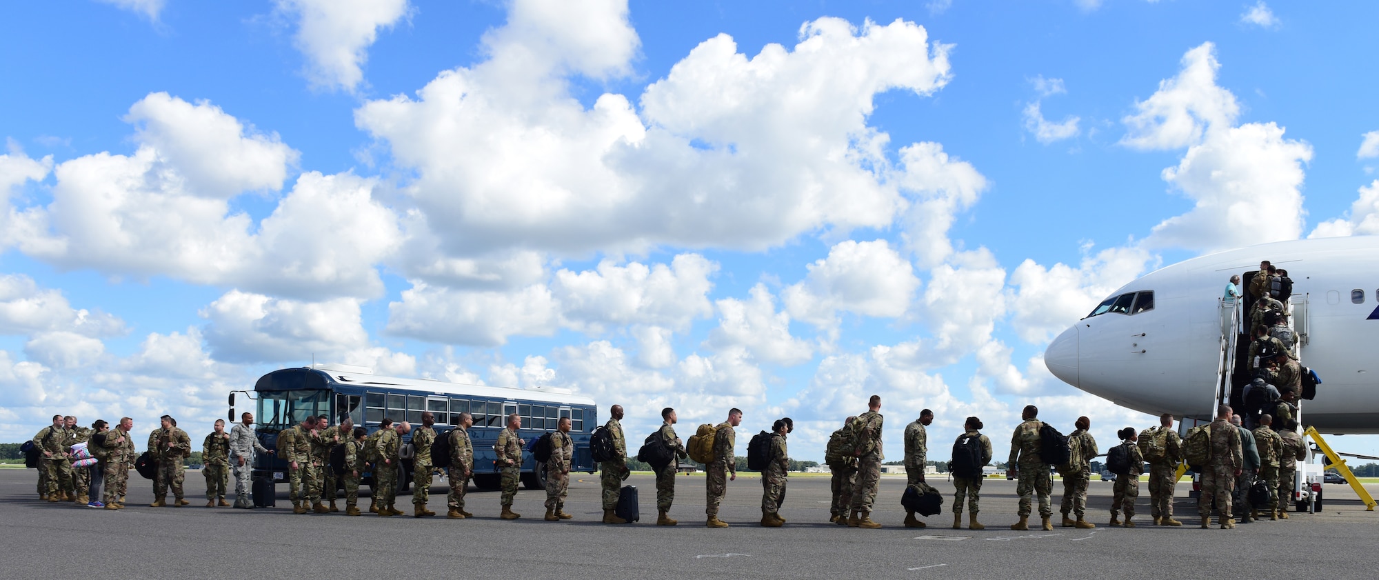 Deploying service members board an aircraft in preparation to deploy through Joint Base Charleston Oct. 15, 2018 in support of the Naval Station Norfolk air terminal while their airfield under goes scheduled maintenance.